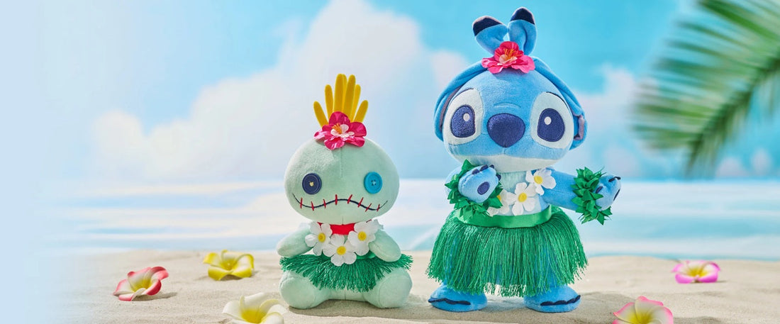Disney Store Japan exclusive Stitch and Scrump plush toys dressed in green grass hula skirts, white flower leis, and pink hibiscus flowers, sitting on a sandy tropical beach with a blue ocean background.