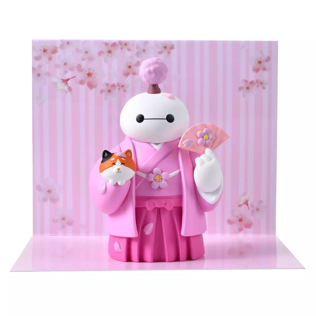 An adorable figure of Baymax from Big Hero 6 dressed in a traditional pink kimono and hakama for the cherry blossom season.