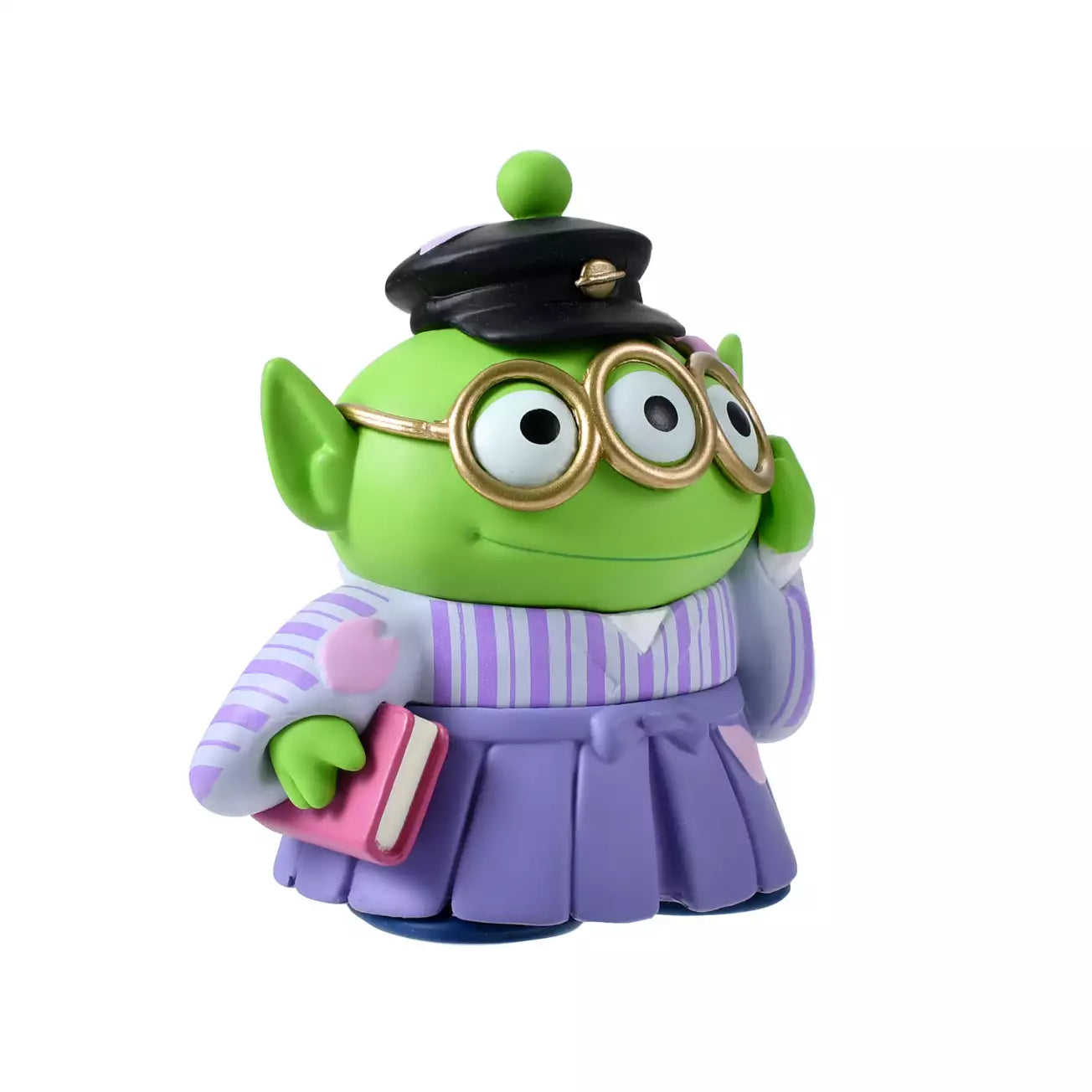A Disney Store Japan exclusive figure of a Little Green Man (Alien) from Toy Story. The character is dressed in a traditional Japanese purple striped hakama and wears a black student cap. It poses with a book in one hand and touches its glasses with the other. The figure is set against a pink striped background with falling cherry blossom petals.