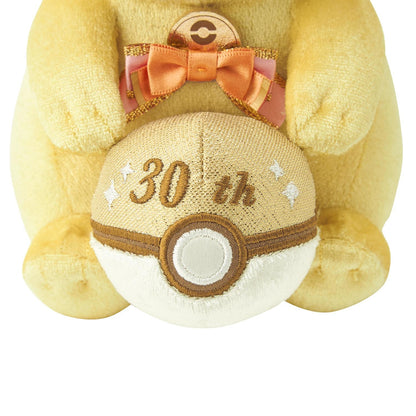 Close-up of the exclusive Pokémon 30th Anniversary Pikachu plush, showing the special golden 'Since 1996' woven tag and delicate glitter fabric.