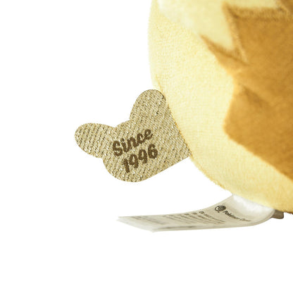 Close-up of the exclusive Pokémon 30th Anniversary Pikachu plush, showing the special golden 'Since 1996' woven tag and delicate glitter fabric.
