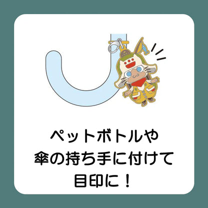 A USJ exclusive Monster Hunter secret collectible charm collection. The image displays a lineup of nine different Palico Felyne characters dressed in various colorful armor sets and outfits, along with one black circle featuring a question mark to represent the rare 'secret' mystery design. There are 10 designs in total to collect in this blind box series.
