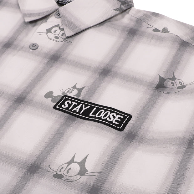 A grey and white plaid button-down shirt from the USJ UNIVRS collection with an all-over print of Felix the Cat's face and a black patch that says 'STAY LOOSE'.