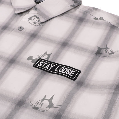 A grey and white plaid button-down shirt from the USJ UNIVRS collection with an all-over print of Felix the Cat's face and a black patch that says 'STAY LOOSE'.