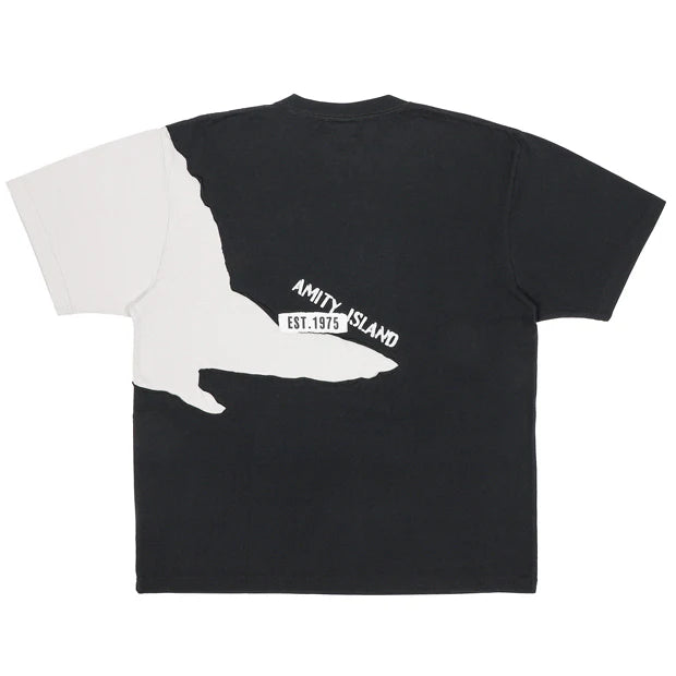 A black and white color-blocked t-shirt from the USJ UNIVRS collection. The shirt features a large graphic of the shark from Jaws with the word 'JAWS' printed below it.