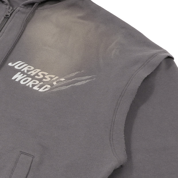 A grey zip-up hoodie from the USJ UNIVRS collection with a subtle graphic of a dinosaur scratching its claws and the text 'JURASSIC WORLD' on the front. The back features four vintage comic panels of dinosaurs.