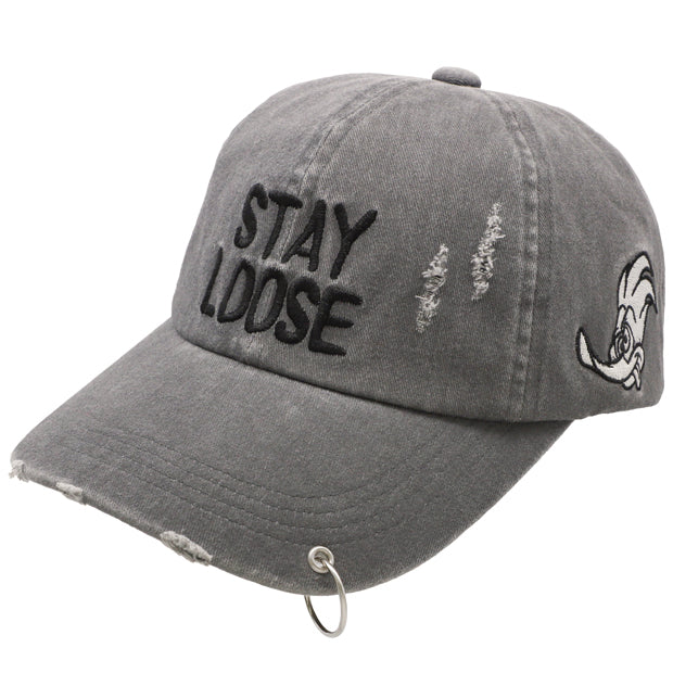 A grey distressed baseball cap from the USJ UNIVRS collection with the text 'STAY LOOSE' embroidered on the front and a small graphic of Woody Woodpecker on the side.