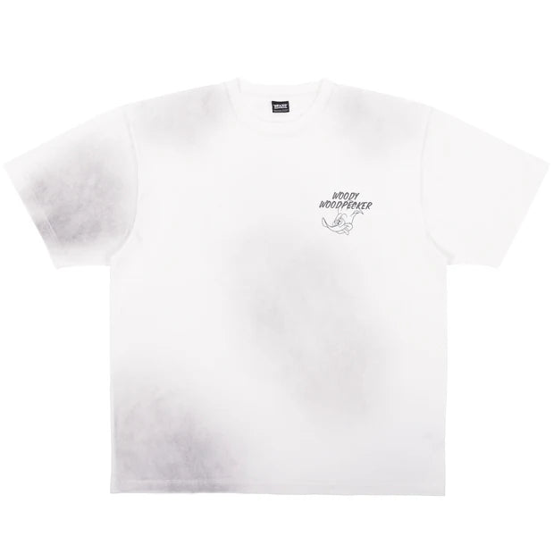 A white oversized t-shirt from the USJ UNIVRS collection featuring a tie-dye effect and a small graphic of Woody Woodpecker laughing with the text 'WOODY WOODPECKER'.