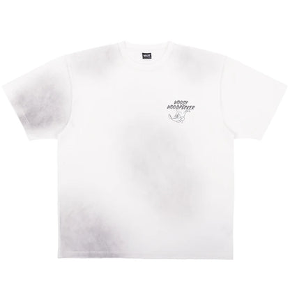 A white oversized t-shirt from the USJ UNIVRS collection featuring a tie-dye effect and a small graphic of Woody Woodpecker laughing with the text 'WOODY WOODPECKER'.