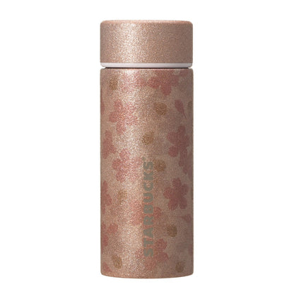 Starbucks Japan SAKURA Shine Brightly 2026 collection merchandise. Limited edition series featuring glitter pink stainless bottles, Stanley collaboration tumblers in pink gradient, and color-changing cups. The design theme highlights vivid spring colors, metallic gold accents, and bright cherry blossom patterns.